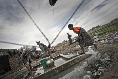 Internflyktingar tillhörande den diskriminerade och förföljda folkgruppen Rohingya hämtar vatten ur en pump i ett läger utanför Sittwe i Myanmar. 